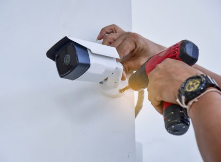 Technician installing CCTV camera for security