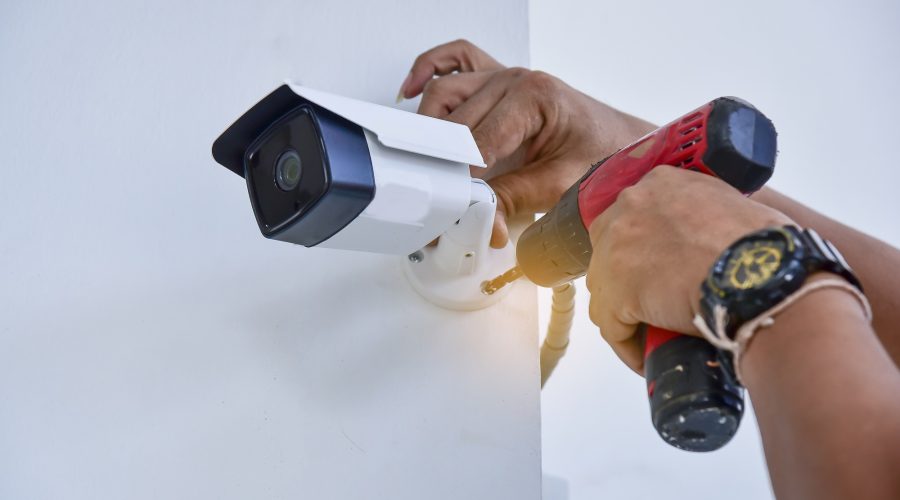 Technician installing CCTV camera for security