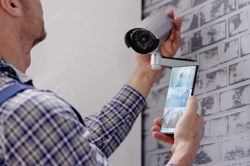 adjusting security surveillance system with CCTV technician
