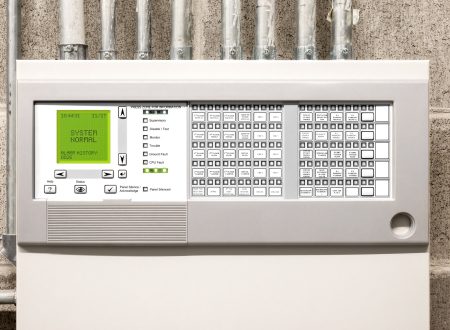 Control panel of single-stage fire alarm system in electrical room of residential or commercial building