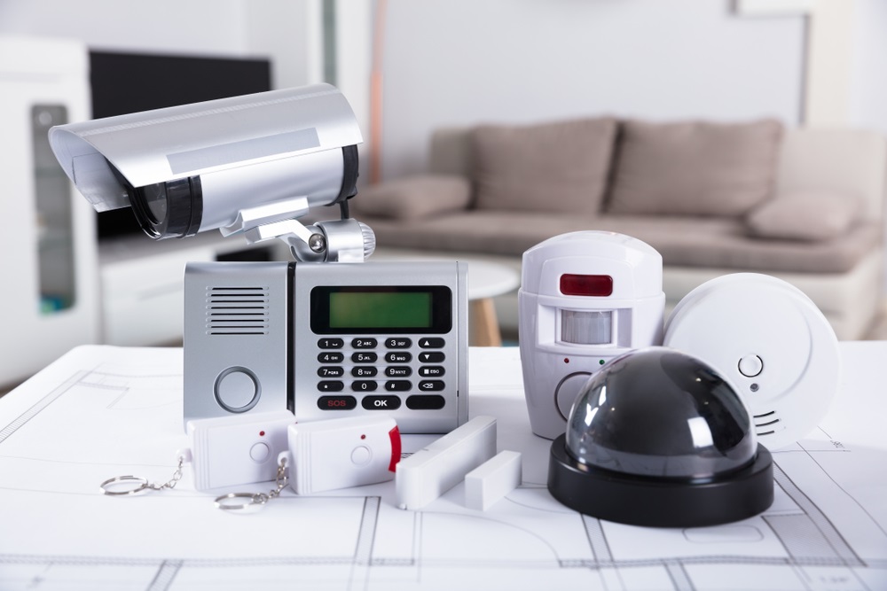Close-up Of Home Security Equipment On Blueprint