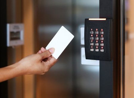 Young woman holding a key card to lock and unlock door