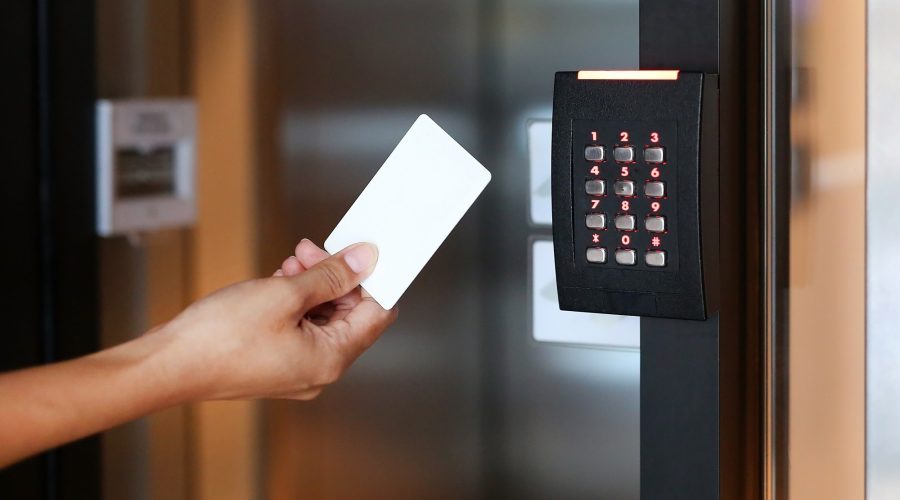 Young woman holding a key card to lock and unlock door