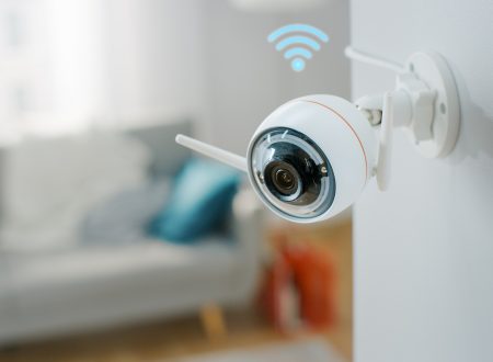 Modern Wi-Fi Surveillance Camera with Two Antennas on a White Wall