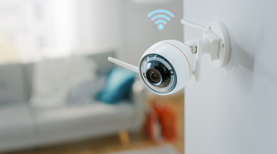 Modern Wi-Fi Surveillance Camera with Two Antennas on a White Wall