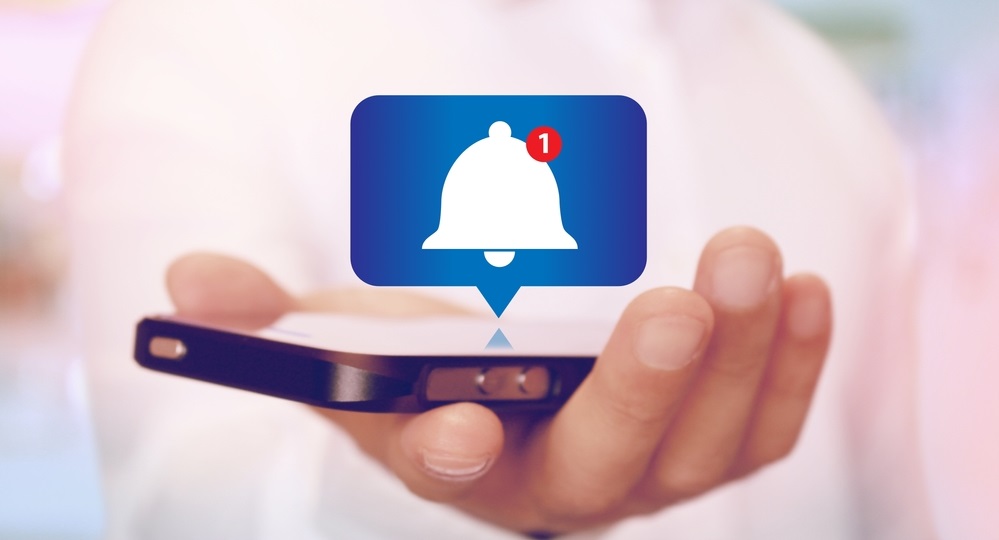 Alert Bell Notification on Smartphone on hand
