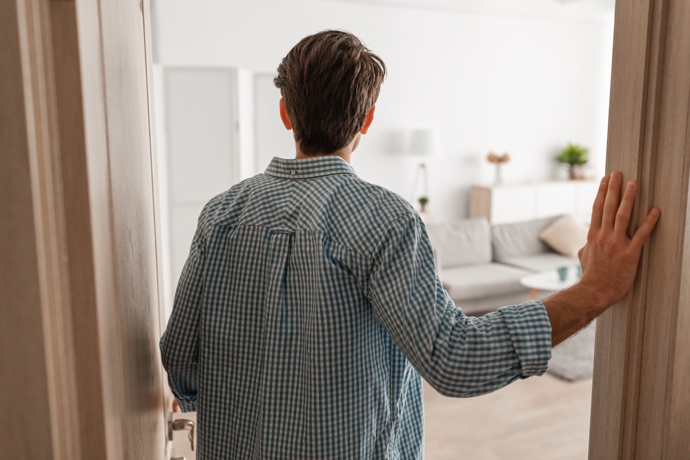 young man walking in his apartment