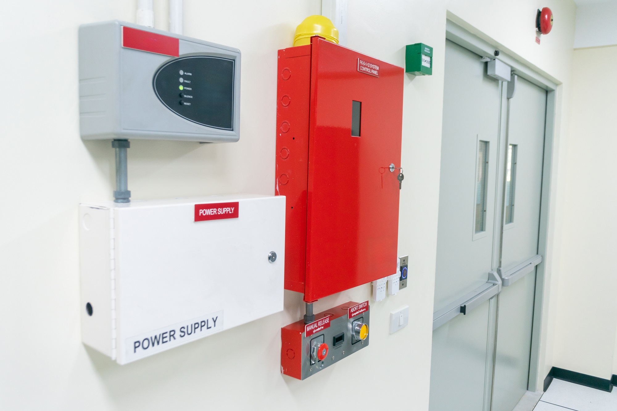 bright red fire alarm system and power supply mounted on the wall